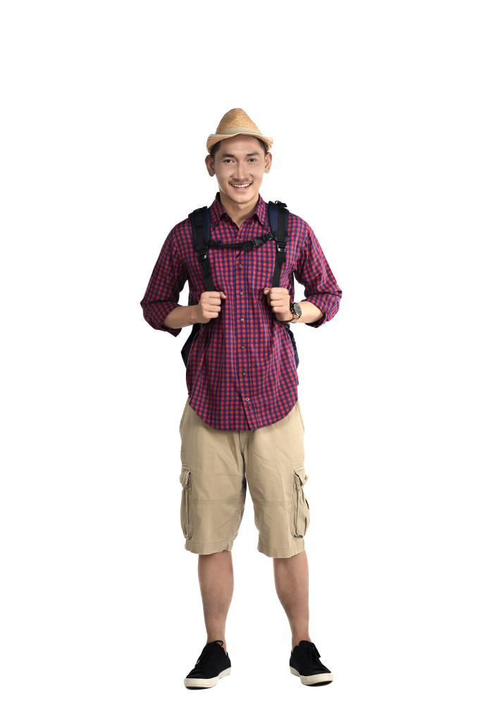 Asian traveler guy wearing backpack and hat isolated over white background