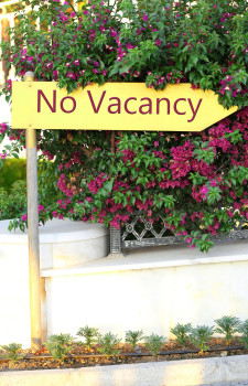 Signboard with text No Vacancy near hotel